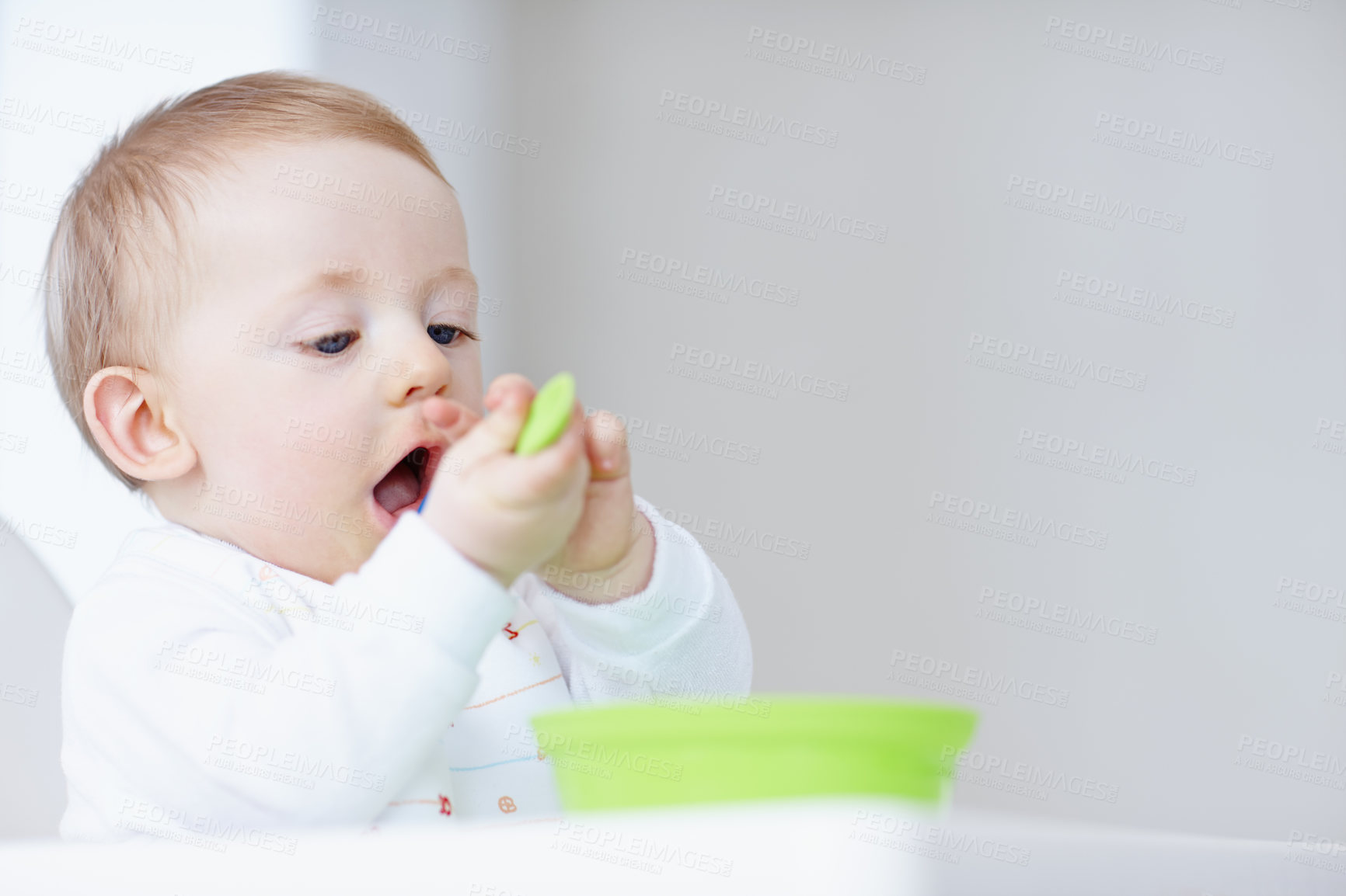 Buy stock photo Cropped image of cute baby boy eating with a plastic spoon