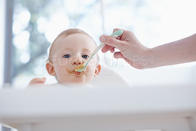 Buy stock photo Low angle view of a baby boy being fed by his mother