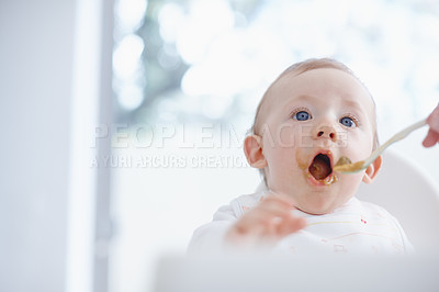 Buy stock photo Cropped image of a baby boy opening his mouth for his mother to feed him