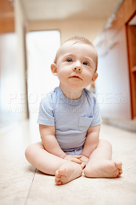 Buy stock photo A baby boy sitting on the kitchen floor