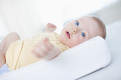 Buy stock photo Baby, lying and play on changing table in home for diaper, cleaning or hygiene in morning. Infant, child and boy in nursery for routine, nappy and development with growth in bedroom at family house