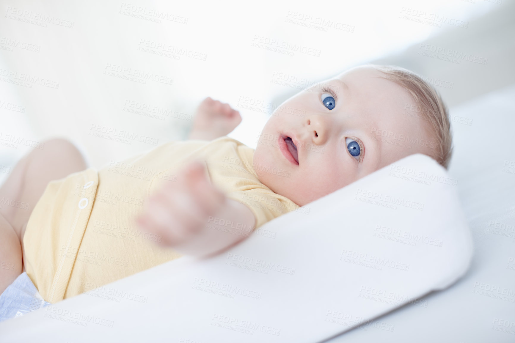 Buy stock photo A cute baby boy lying on his changing table