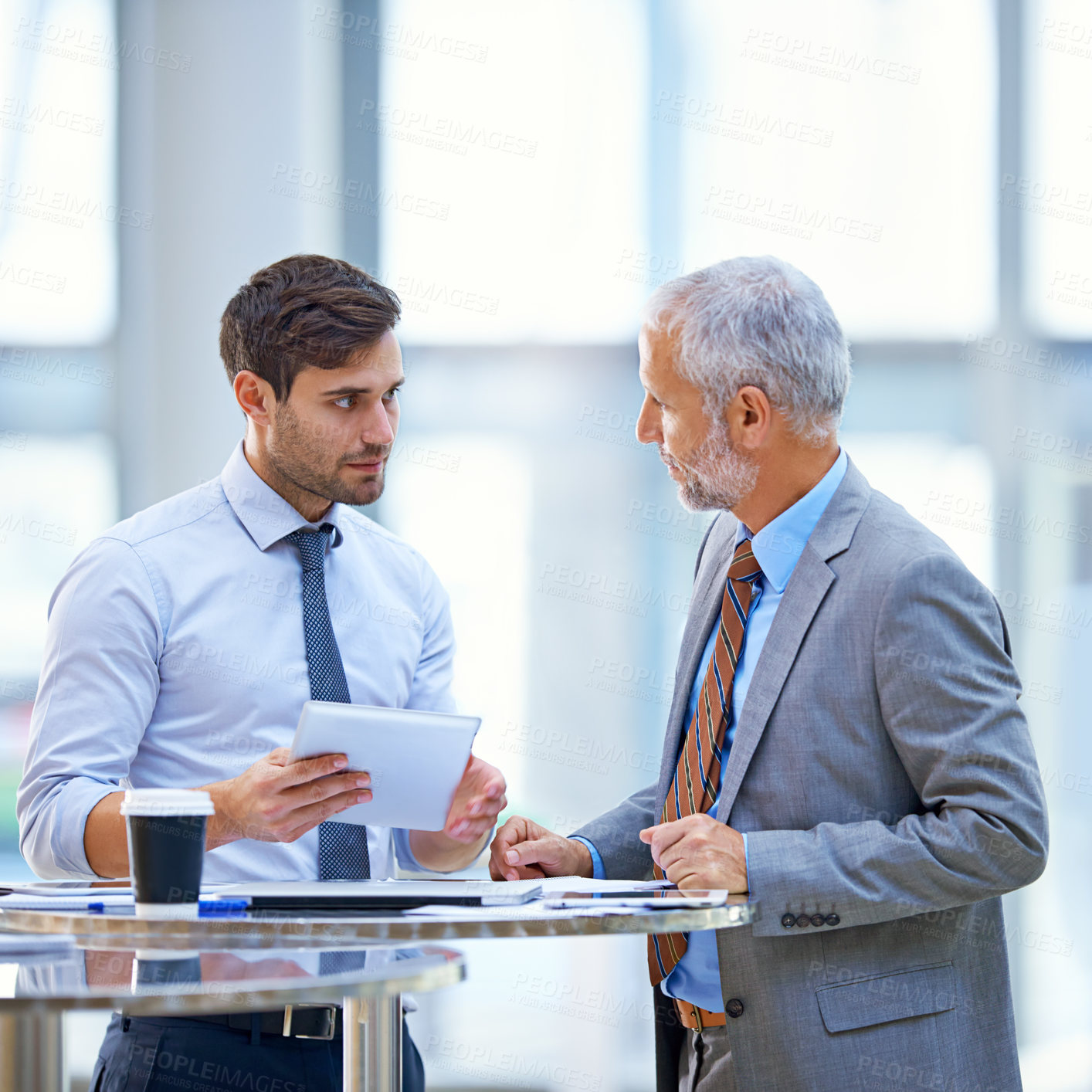 Buy stock photo Discussion, tablet and business development team talking and in collaboration in a meeting for online information. Together, mentor and senior businessman coaching young person in training for job