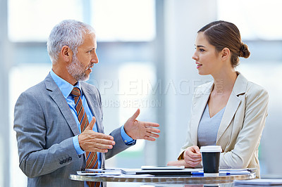 Buy stock photo Shot of two business colleagues discussing work in the office