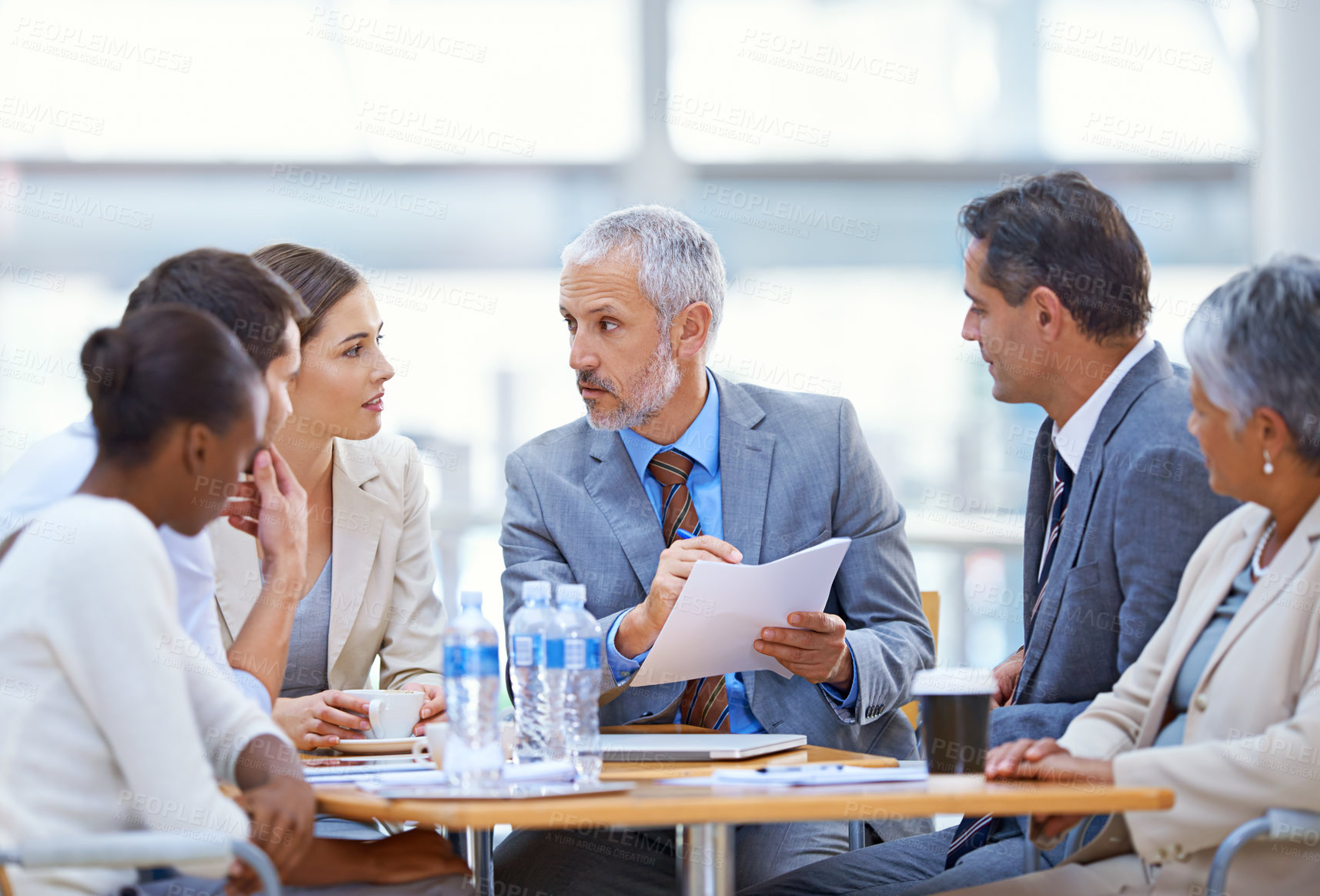 Buy stock photo Shot of a group of businesspeople having a boardroom meeting