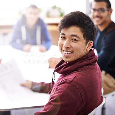 Buy stock photo Portrait of a happy young man sitting in a meeting with his colleagues