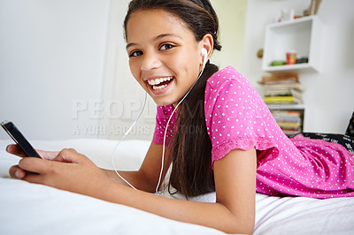 Buy stock photo Shot of a teenage girl listening to music in her bedroom