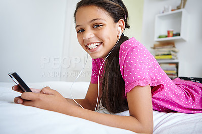 Buy stock photo Shot of a teenage girl listening to music in her bedroom