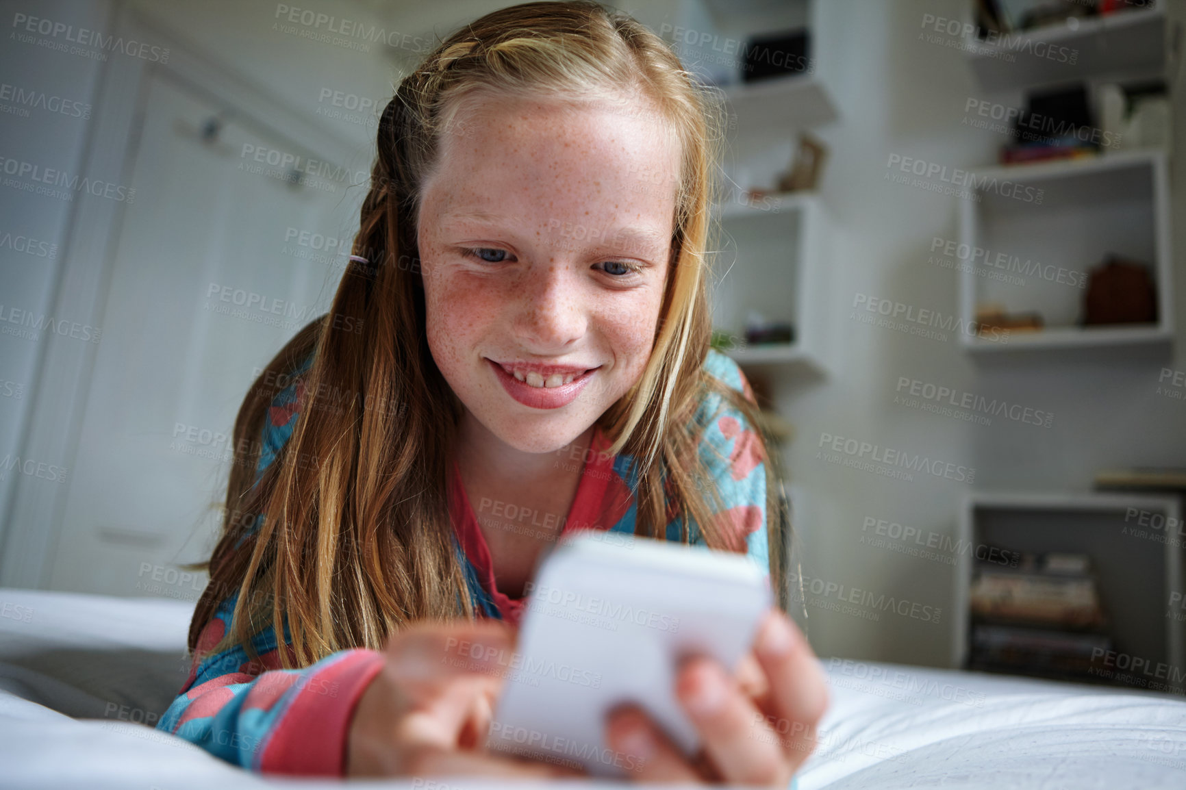 Buy stock photo Shot of a teenage girl texting in her bedroom