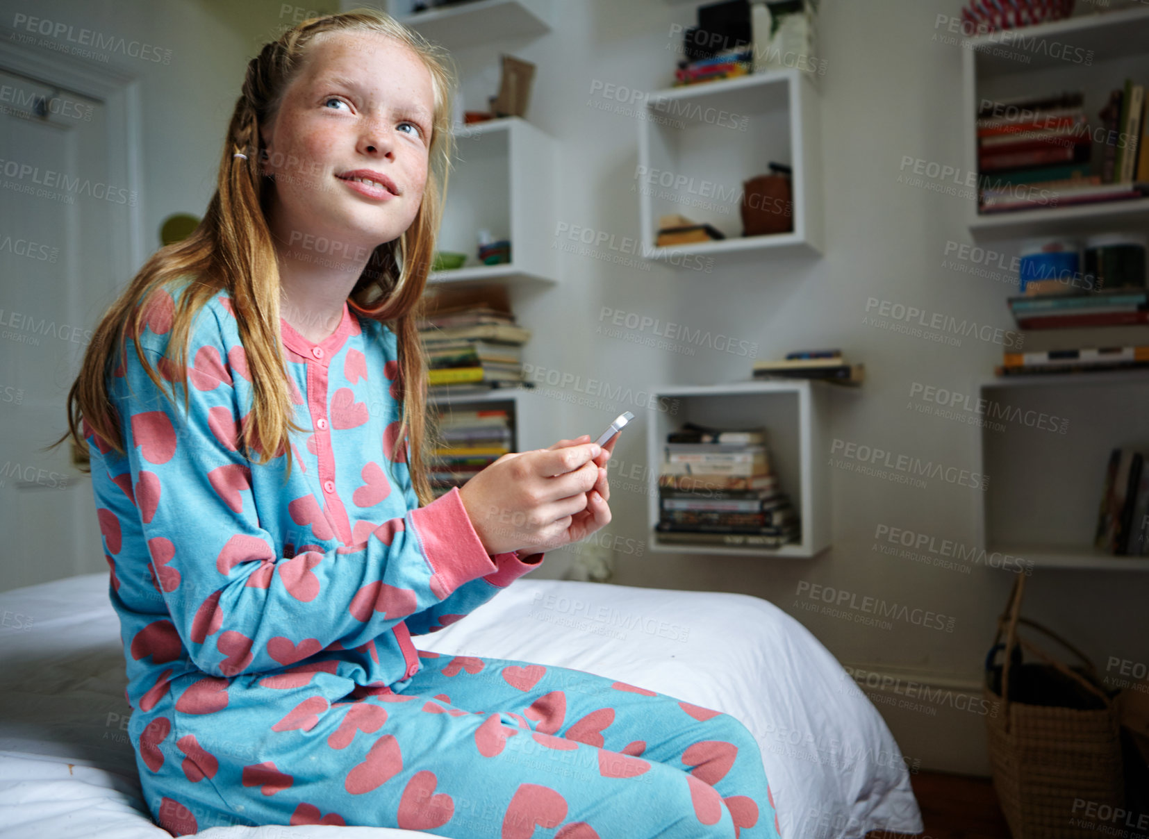 Buy stock photo Shot of a teenage girl texting in her bedroom