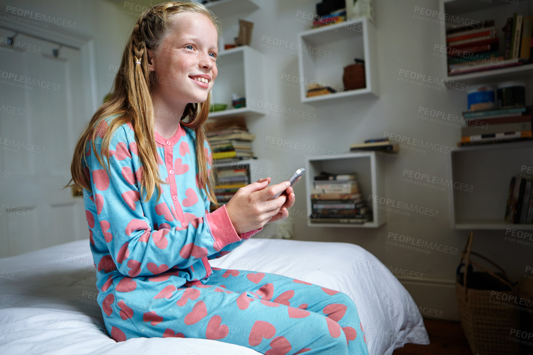 Buy stock photo Shot of a teenage girl texting in her bedroom