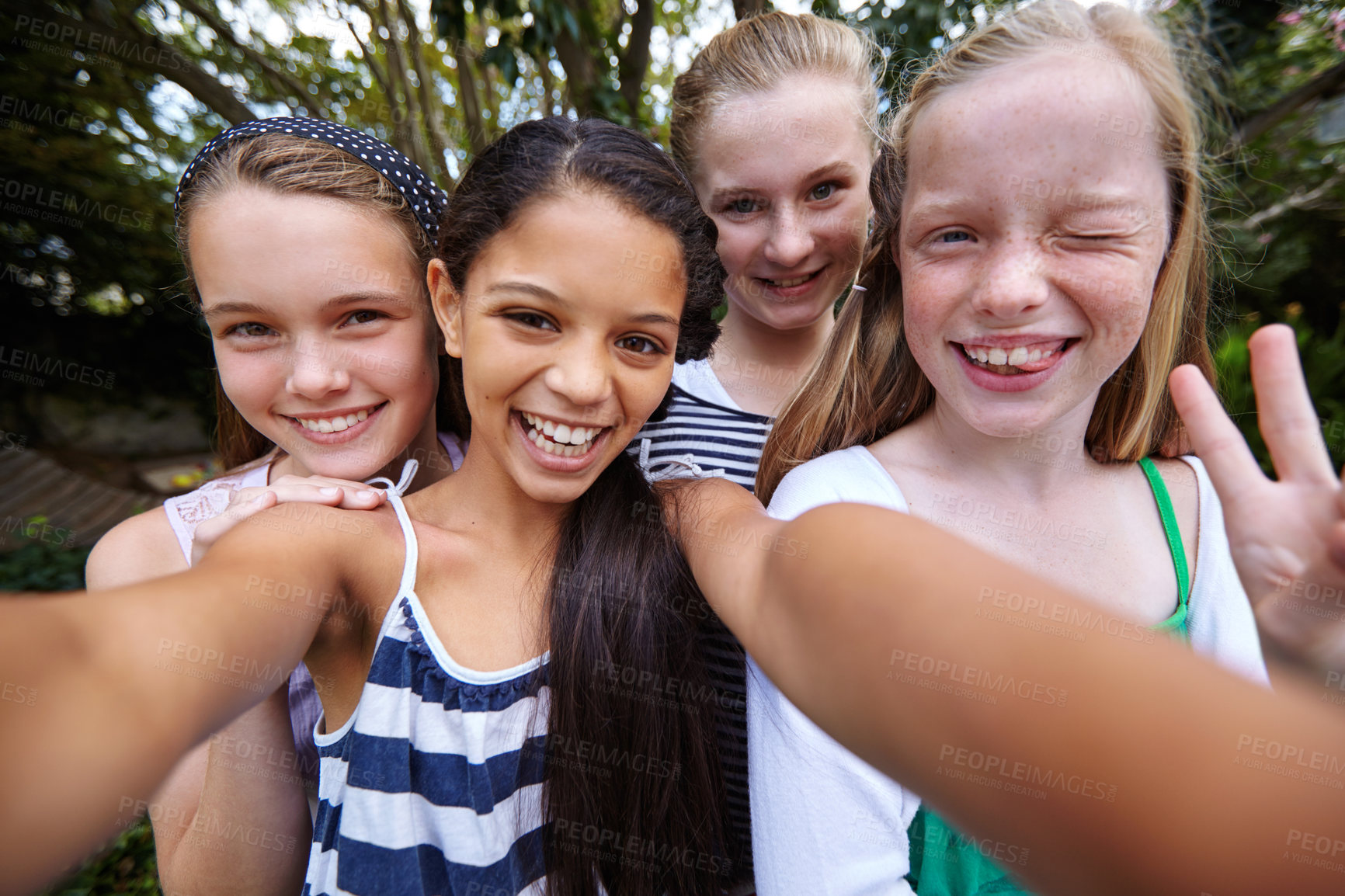 Buy stock photo Shot of a group of young girl friends taking a selfie together outside