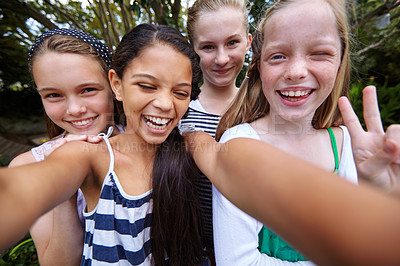 Buy stock photo Shot of a group of young girl friends taking a selfie together outside