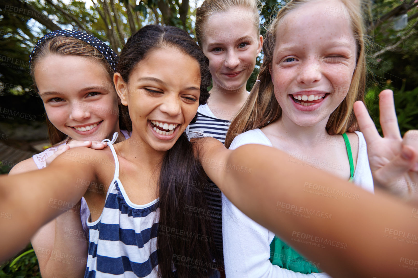 Buy stock photo Shot of a group of young girl friends taking a selfie together outside