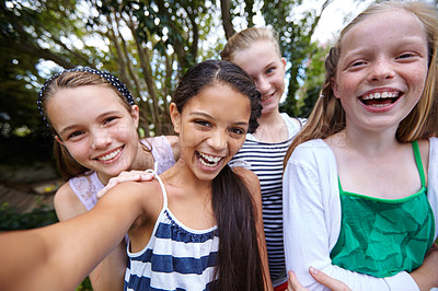 Buy stock photo Shot of a group of young girl friends taking a selfie together outside