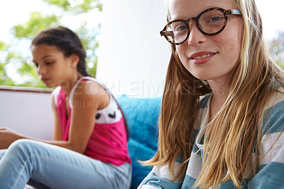 Buy stock photo Shot of two teenage friends hanging out indoors