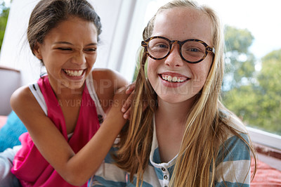 Buy stock photo Shot of two teenage friends spending time together indoors