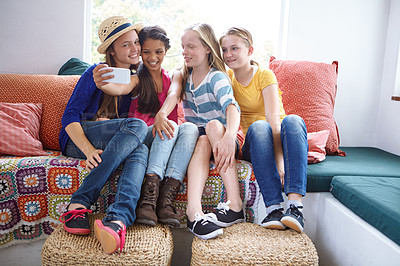 Buy stock photo Shot of a group of teenage friends taking a selfie together