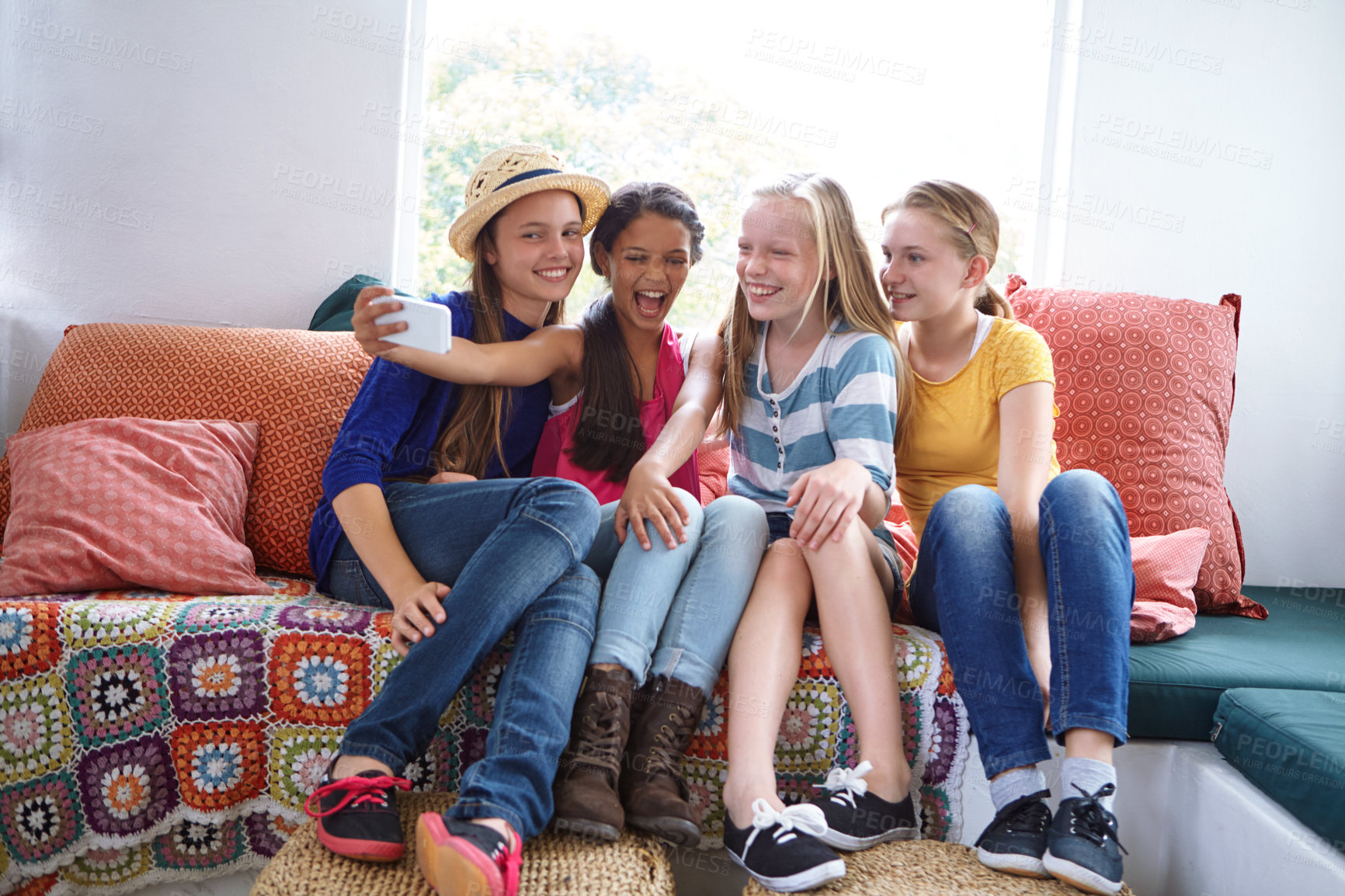 Buy stock photo Shot of a group of teenage friends taking a selfie together