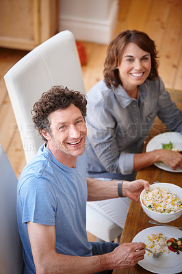 Buy stock photo Portrait of a smiling couple having a meal together