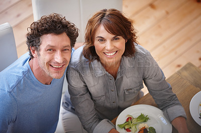 Buy stock photo Portrait of a smiling couple having a meal together