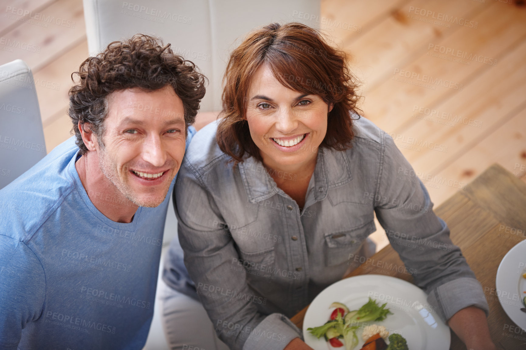 Buy stock photo Portrait of a smiling couple having a meal together