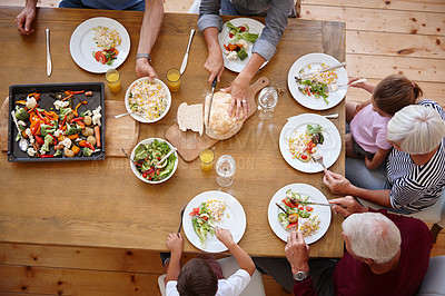 Buy stock photo High angle shot of a multi generational family sharing a meal together