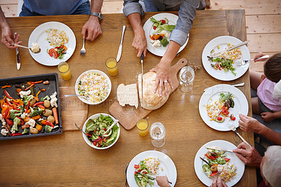 Buy stock photo High angle shot of a family sharing a meal together