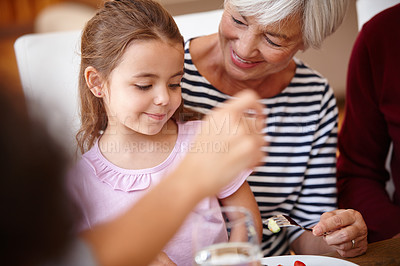 Buy stock photo Cropped shot of a senior woman having lunch with her grandchild