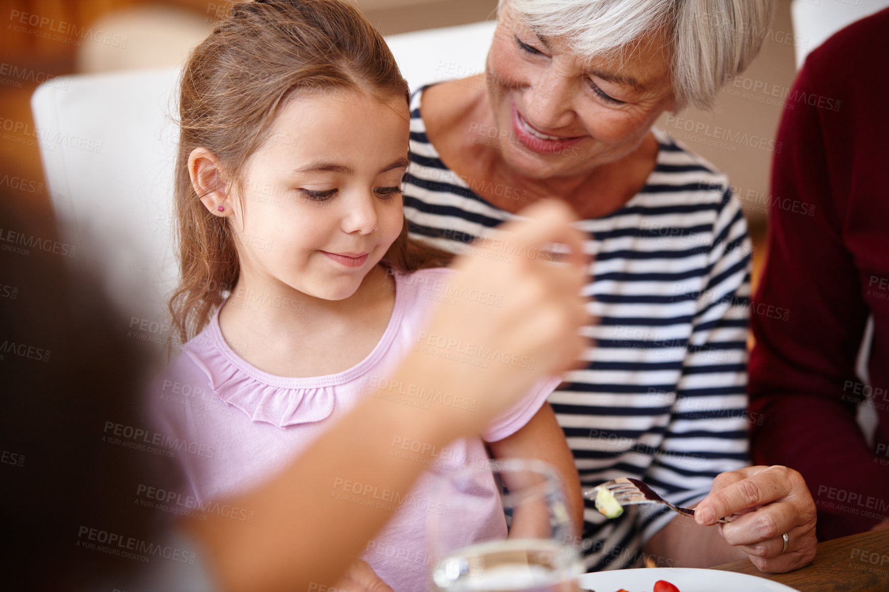 Buy stock photo Cropped shot of a senior woman having lunch with her grandchild