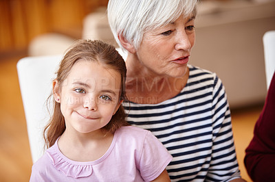 Buy stock photo Portrait of a little girl sitting on her grandmother's lap
