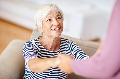 Buy stock photo Shot of a senior woman holding her daughter's hand