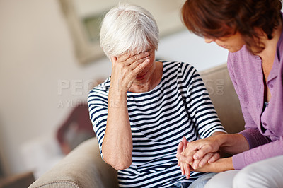 Buy stock photo Shot of a woman comforting her elderly mother who's upset