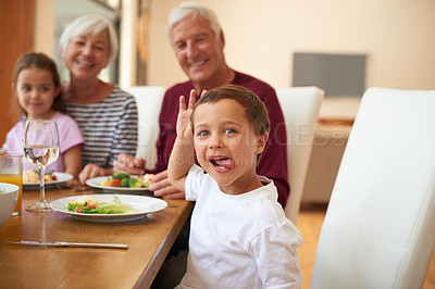 Buy stock photo Portrait of a little boy having a meal with his grandparents