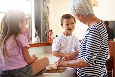 Buy stock photo Cropped shot of a grandmother washing vegetables with her grandchildren in a kitchen