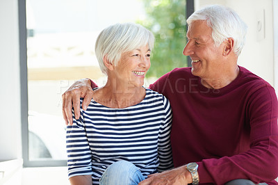 Buy stock photo Shot of a loving senior couple sitting together at home