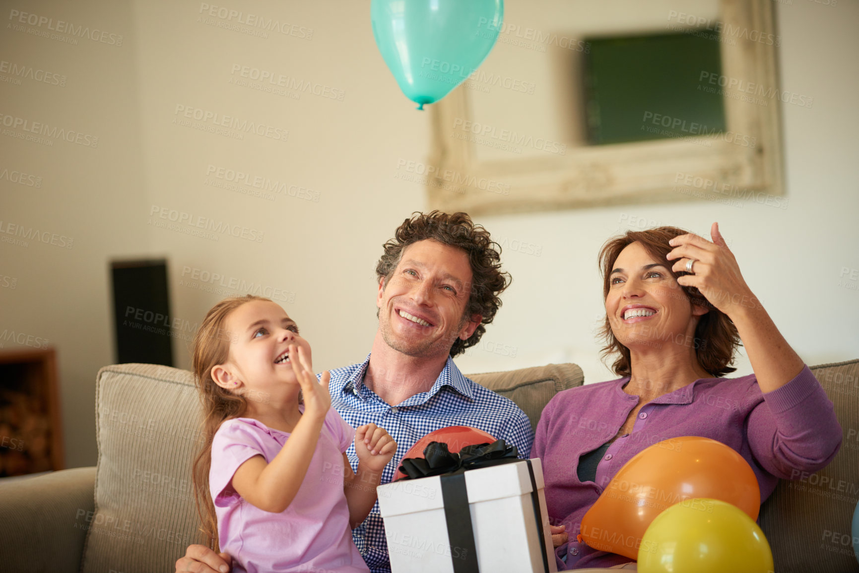 Buy stock photo Shot of a happy little girl celebrating her birthday with her family