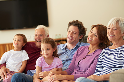 Buy stock photo Shot of a multi generational family sitting on a sofa at home