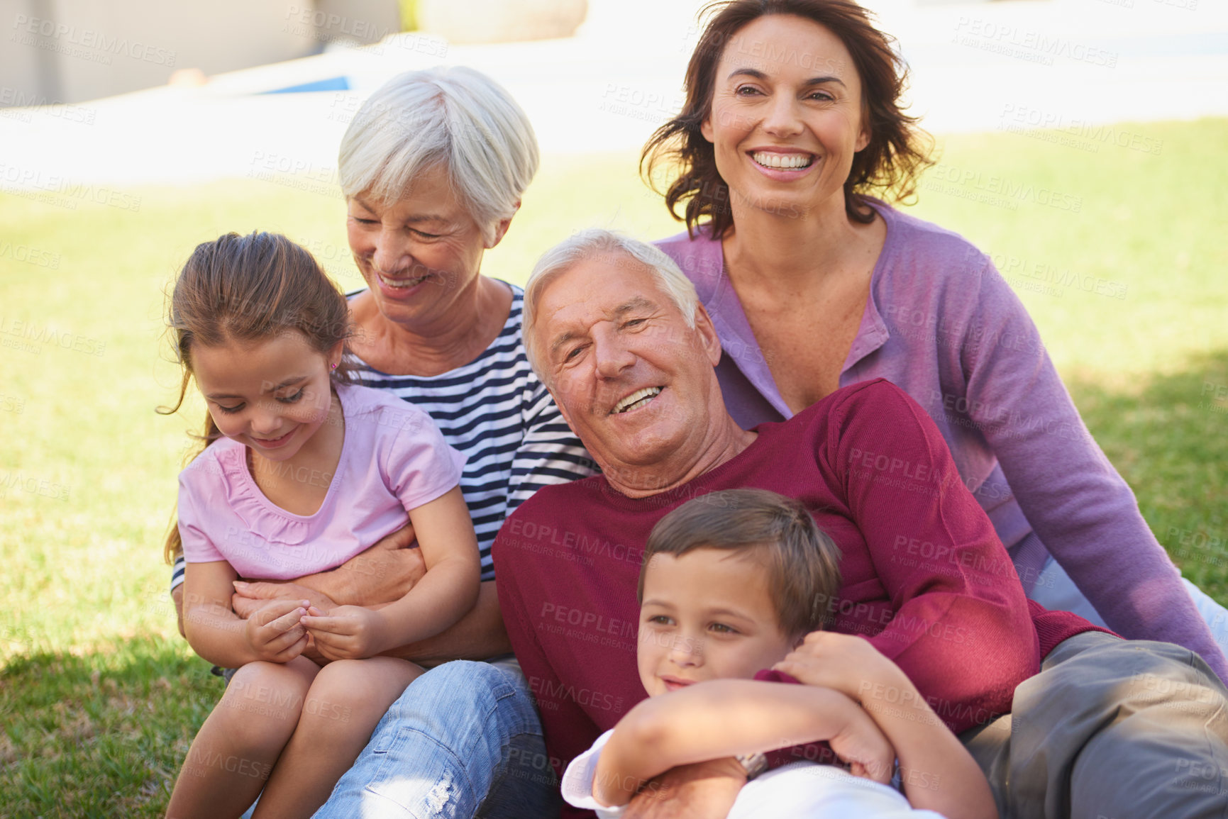 Buy stock photo Cropped shot of a multi-generational family spending time together outside