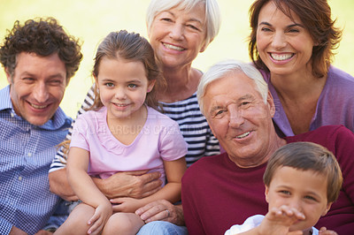 Buy stock photo Cropped shot of a multi-generational family spending time together outside