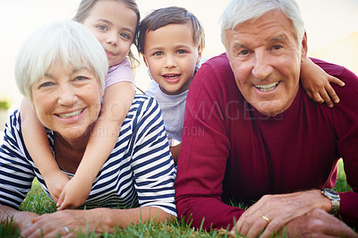 Buy stock photo Cropped portrait of a senior couple spending time with their grandchildren