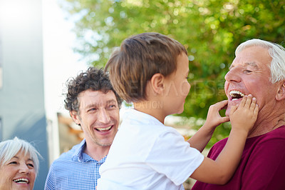 Buy stock photo Shot of a multi-generational family spending time together outside