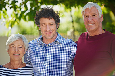 Buy stock photo Cropped portrait of a senior couple standing outside with their son