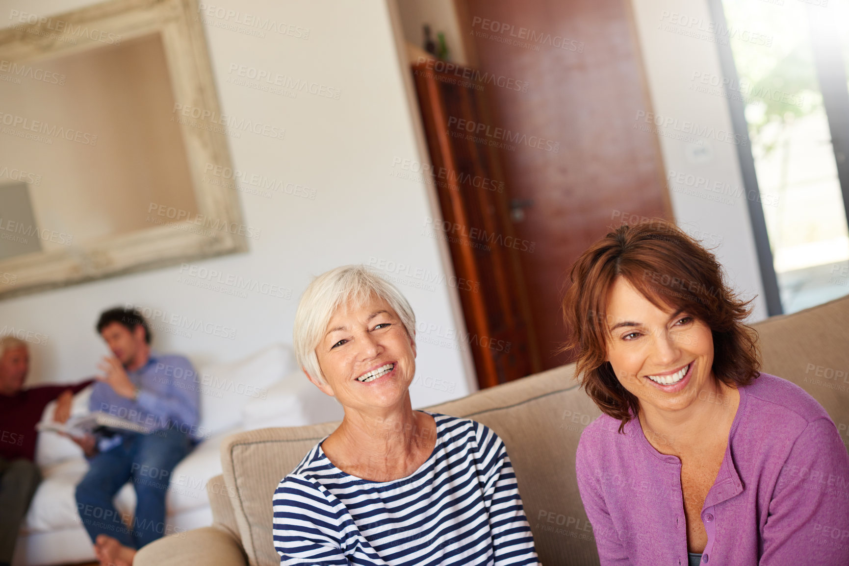 Buy stock photo Portrait of a senior woman sitting beside her daughter at home