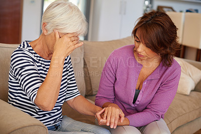 Buy stock photo Shot of a woman comforting her elderly mother who's going through a tough time