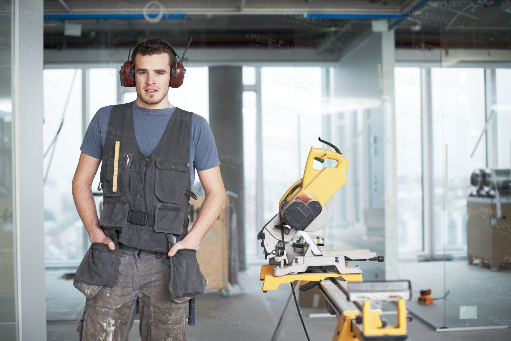 Buy stock photo Handsome young contractor standing on a construction site