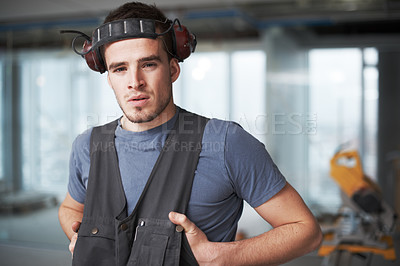 Buy stock photo Handsome young contractor standing on a construction site