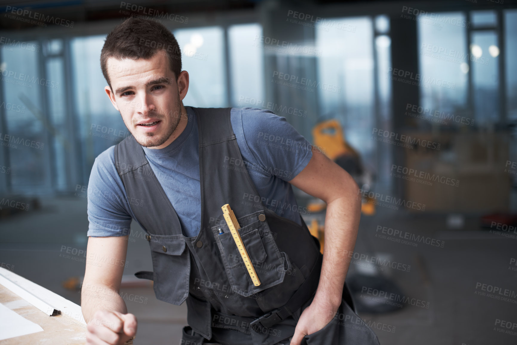 Buy stock photo Portrait of one young building contractor working on industrial architecture project at construction site. Civil engineer and builder installing, fixing and renovating property for development
