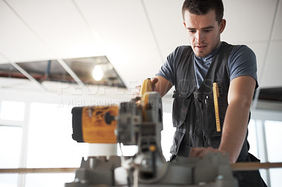 Buy stock photo One focused young contractor from below using power saw equipment and tools to renovate and remodel building. Civil engineer or builder working on industrial architecture project at construction site