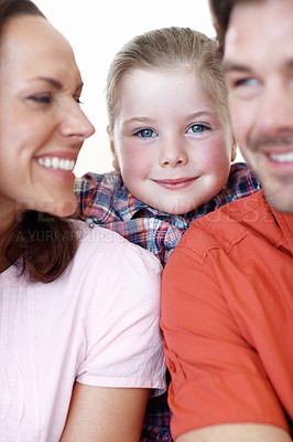 Buy stock photo A young girl smiles, framed be her parents